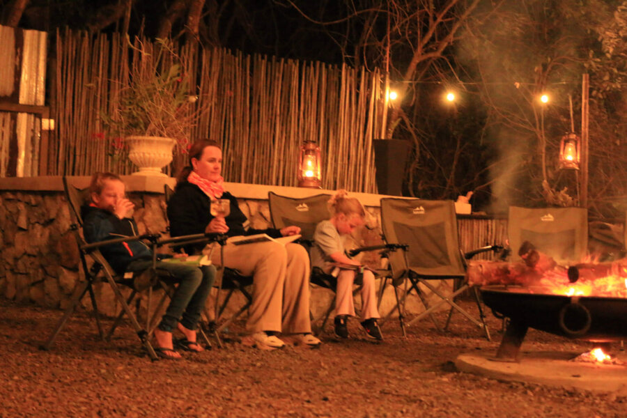 Sharing stories around the lodge's boma