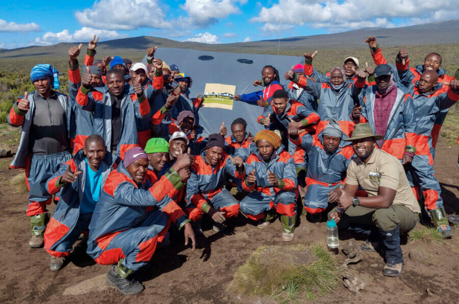 Happy guides and porters hiking Mount Kilimanjaro