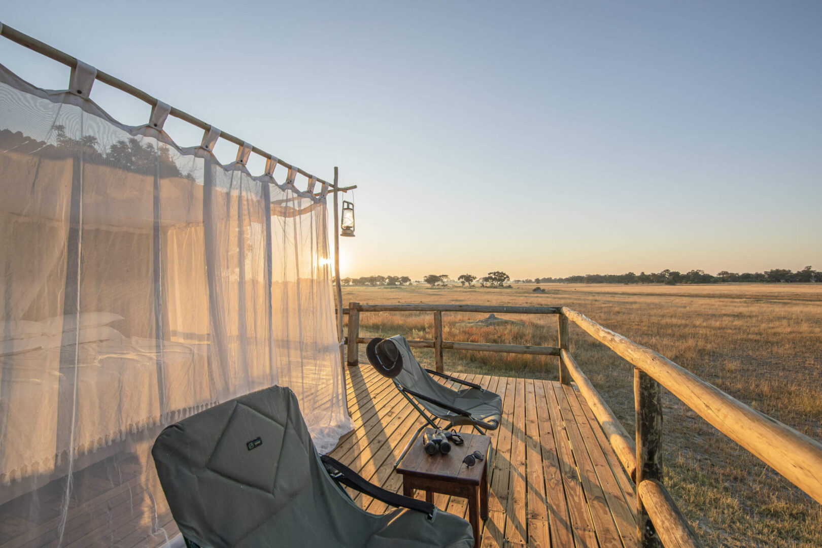 A sleepout setup in the Okavango Delta featuring cozy bedding under mosquito nets
