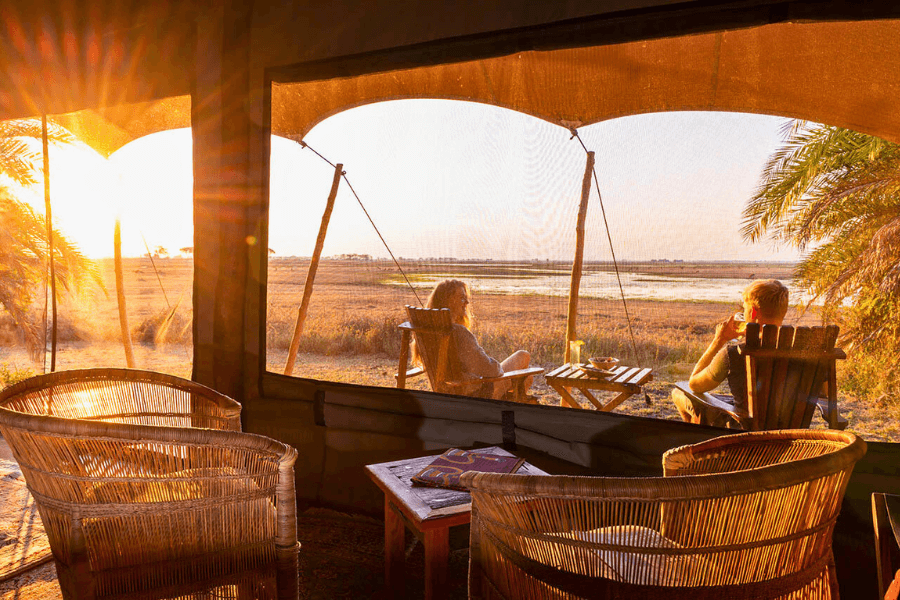 A couple enjoying the panoramic view of the Busanga Plains from their safari accommodation